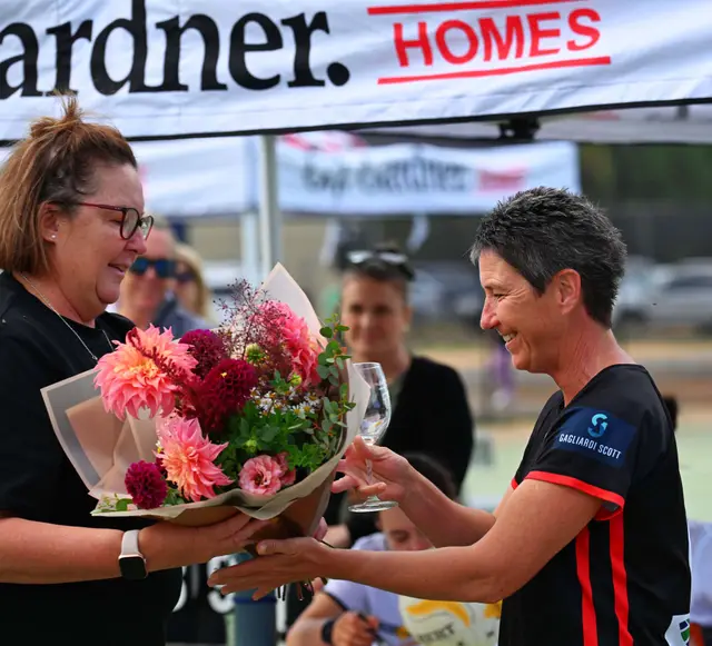Flowers presented at a Waaia presentation, in front of a banner