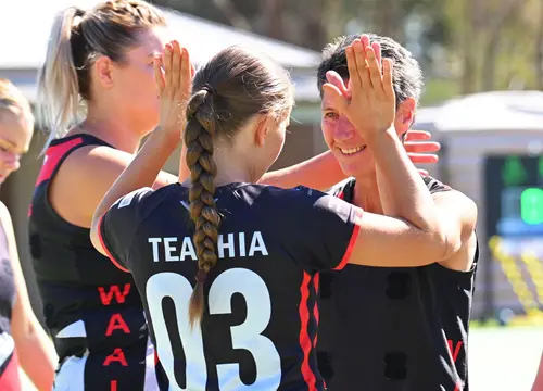 Waaia netballers high-five on court